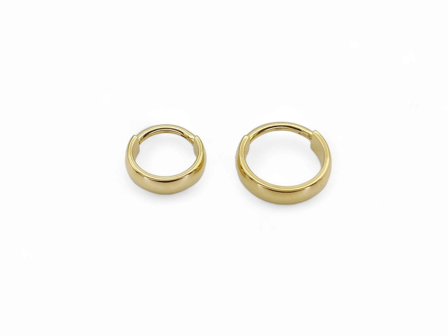 Titanium gold band clicker ring on a white background