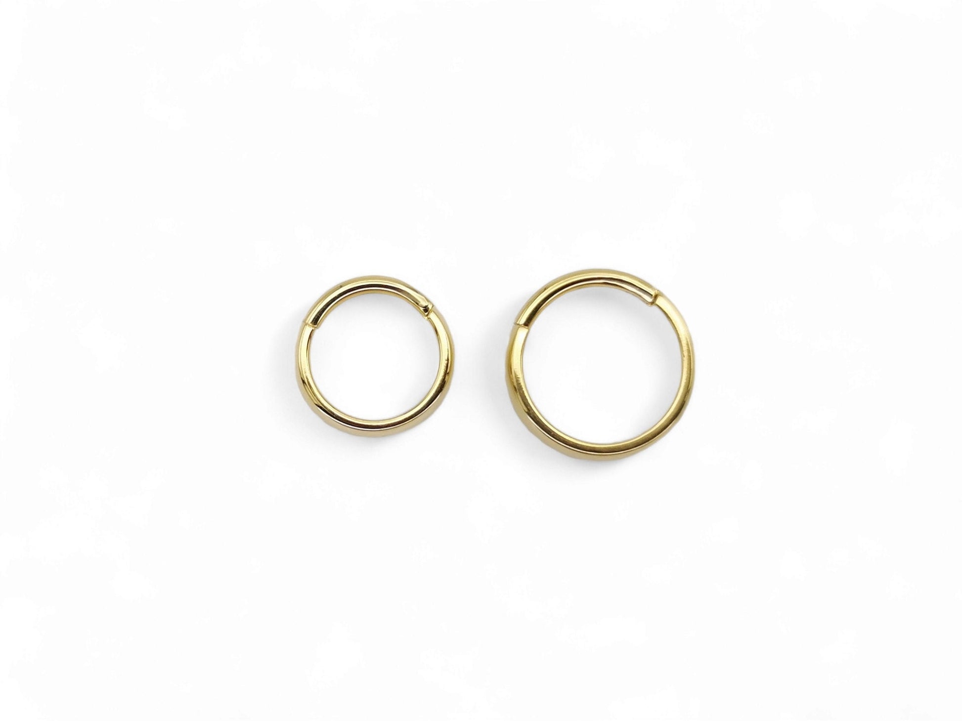 Titanium gold band clicker ring on a white background