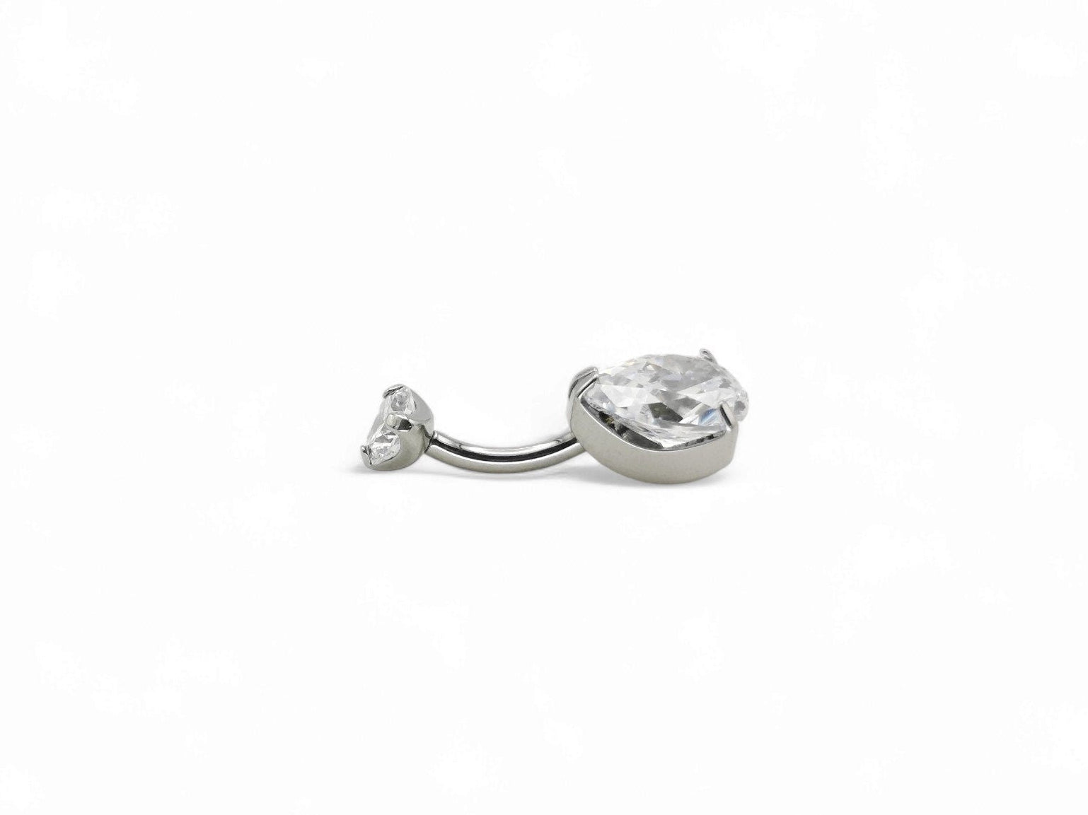Titanium jewelled claw set belly bar on a white background