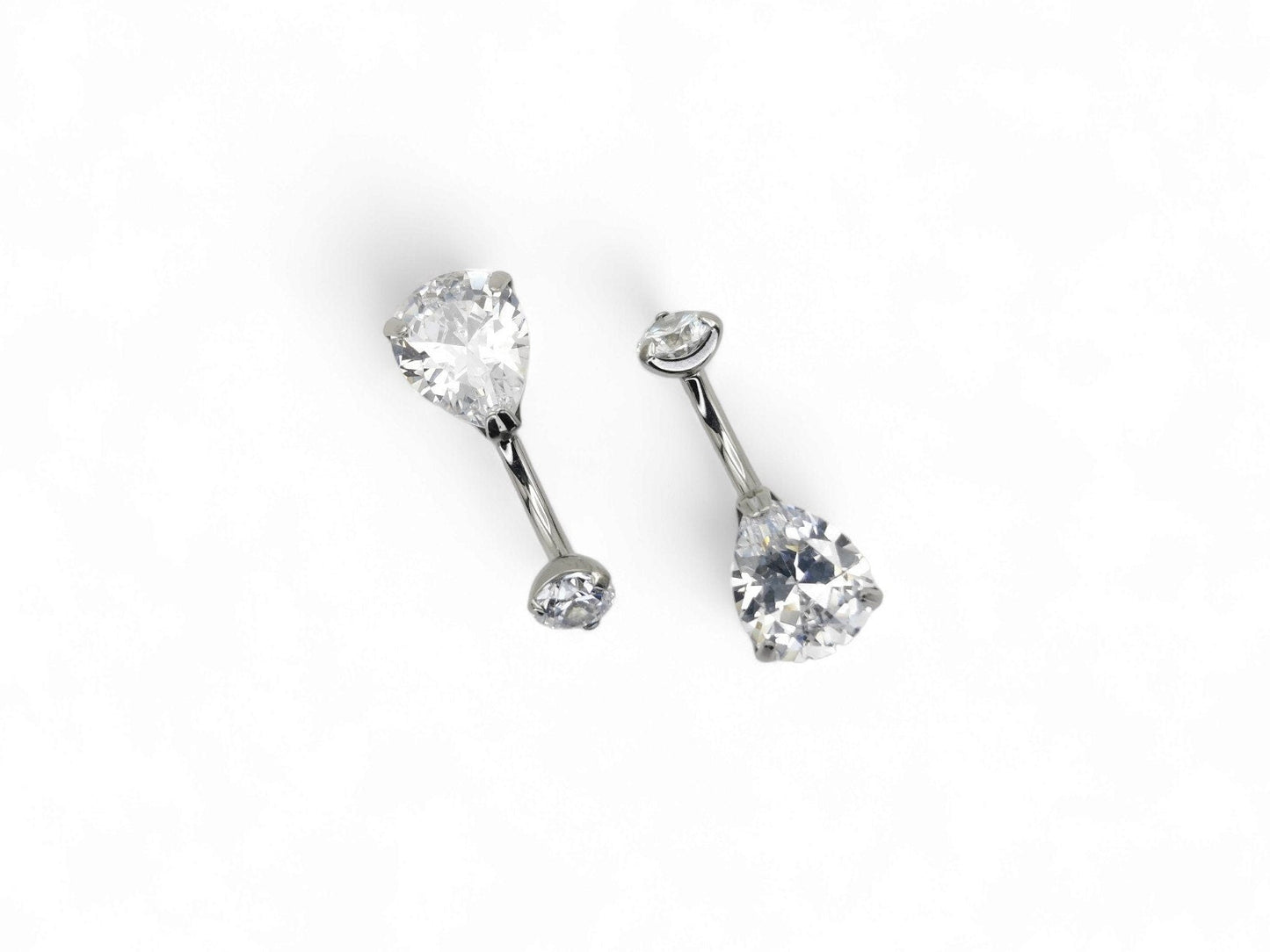Titanium jewelled claw set belly bar on a white background