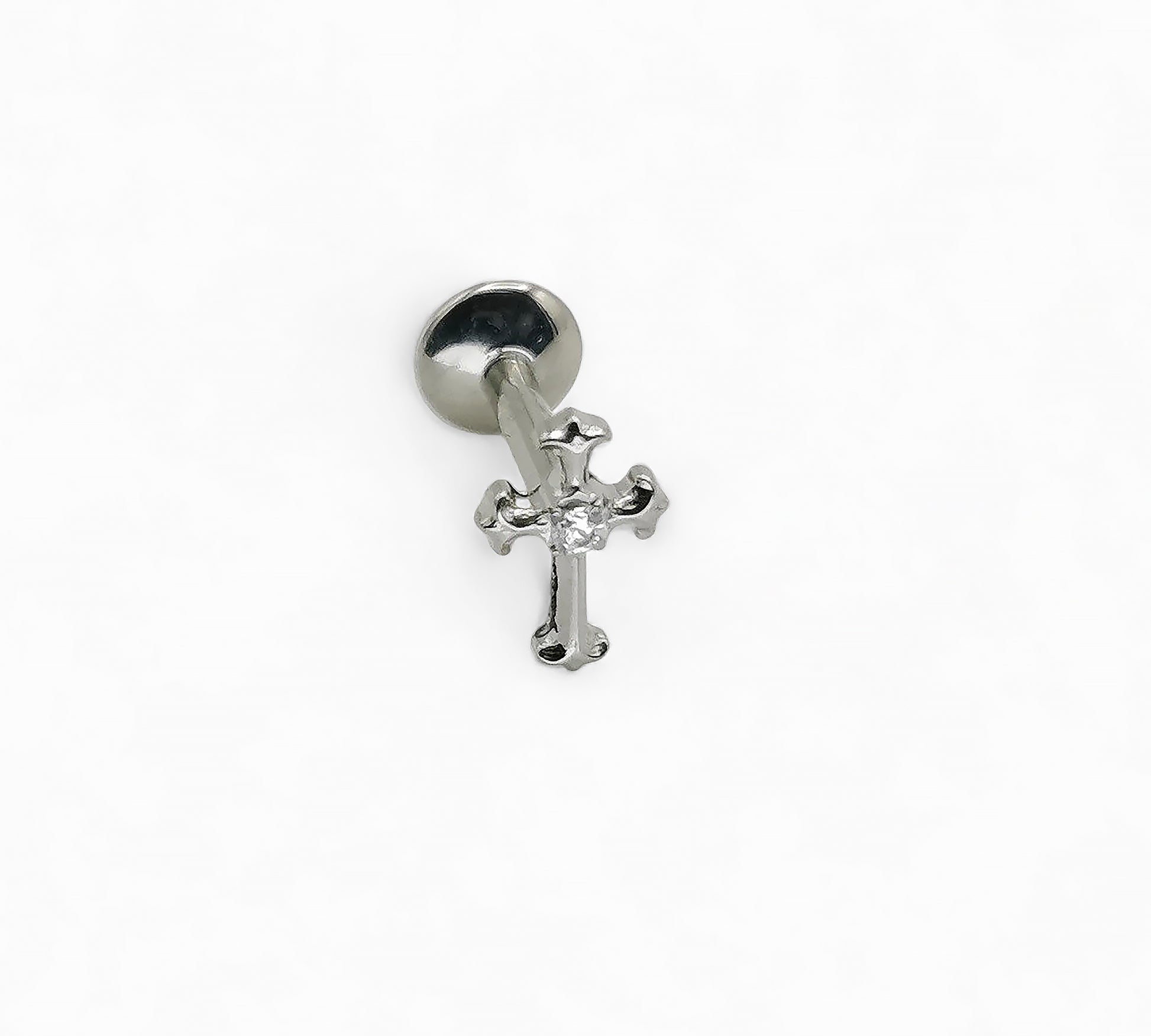 Silver cross charm on a white background