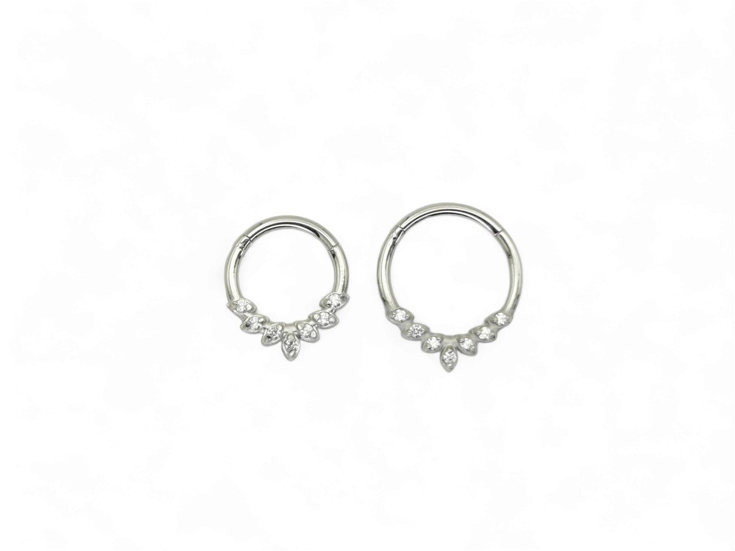 A pair of Titanium jewelled clicker rings with a laurel wreath detail, featuring cubic zirconia jewels.