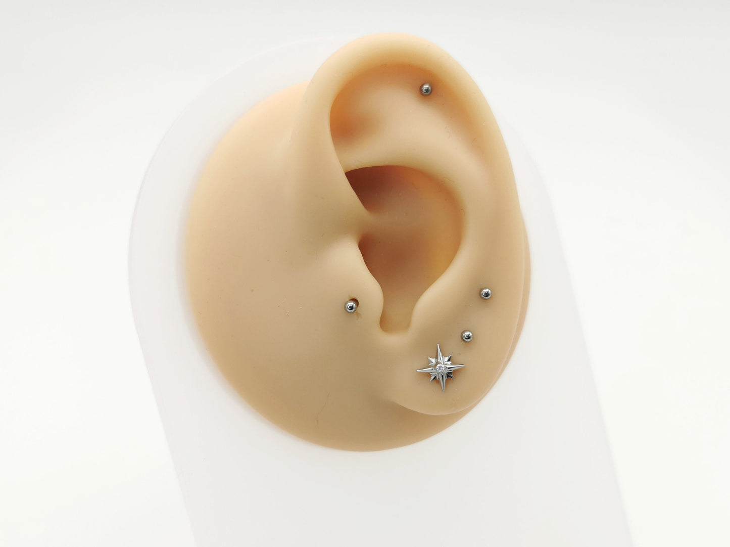 Titanium jewelled star stud on a mannequin ear