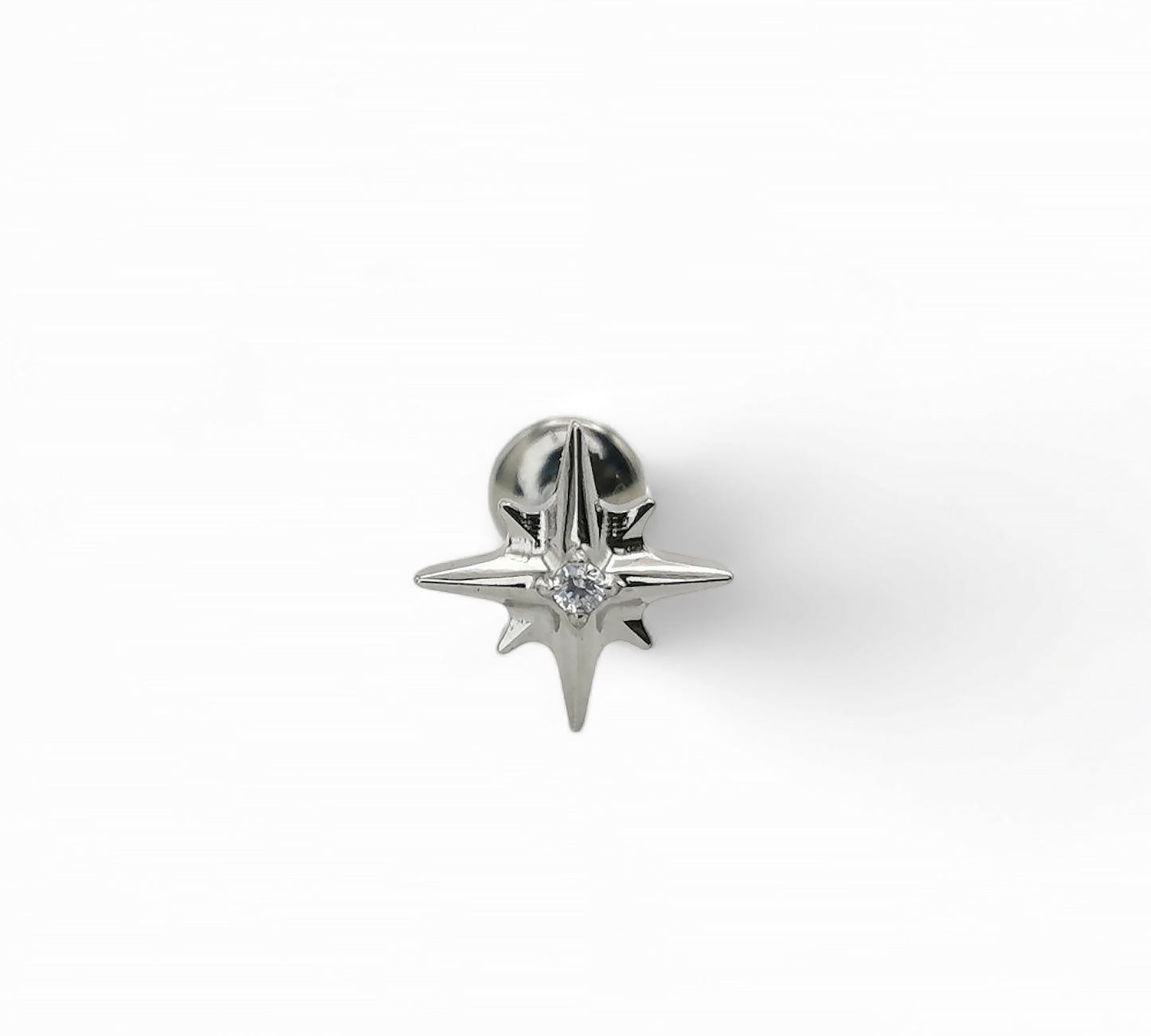 Silver star-shaped earring on a white background