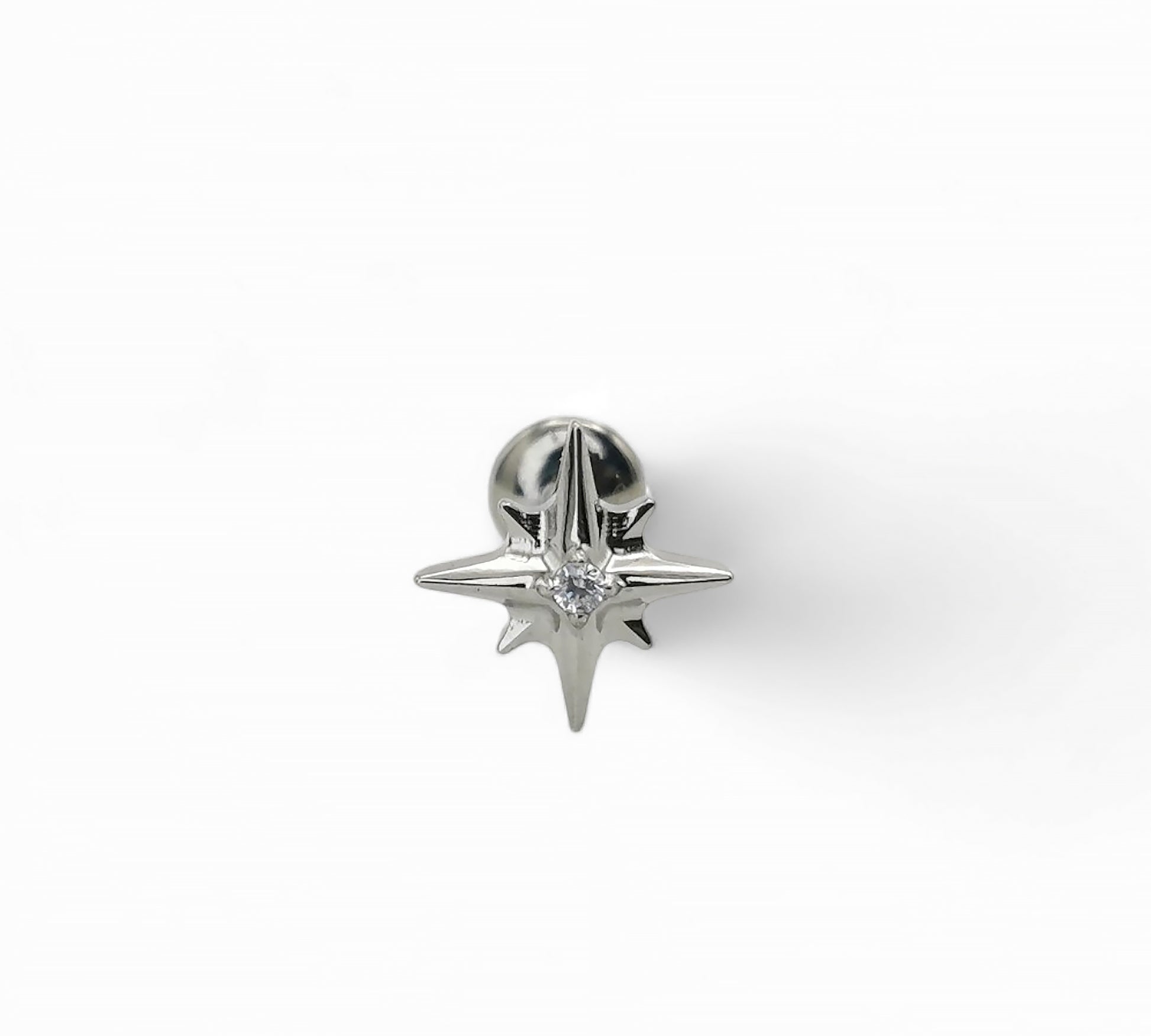 Silver star-shaped earring on a white background