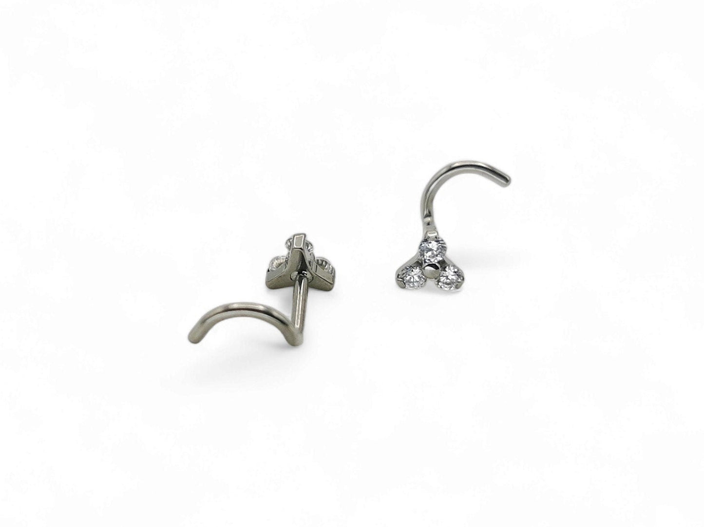 Titanium jewelled trinity nostril stud on a white background