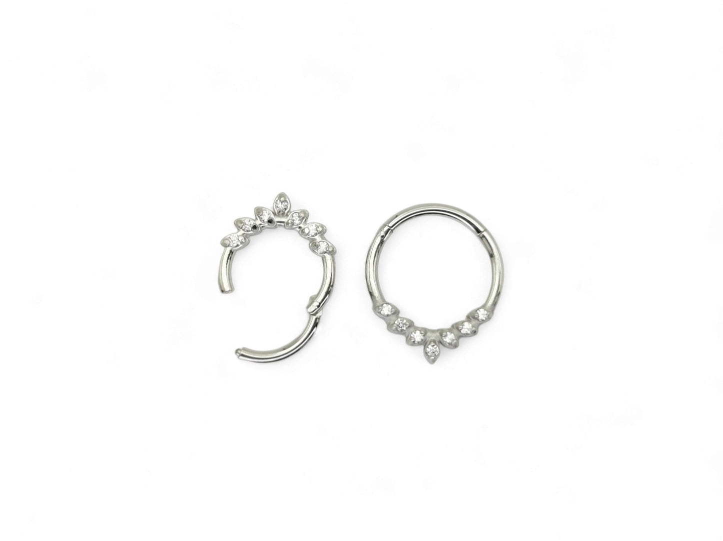 A pair of titanium jewelled clicker rings with a laurel wreath detail, featuring cubic zirconia jewels.