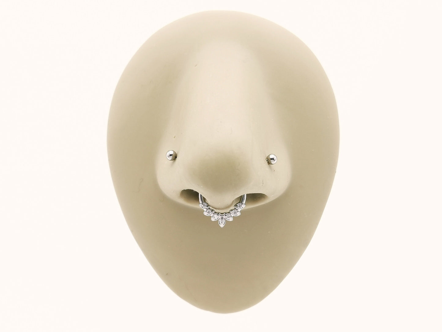 Titanium laurel wreath clicker on a mannequin nose