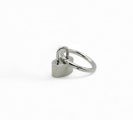 A high-polish titanium padlock charm with a keyhole, designed to be attached to a ring for use with piercings.