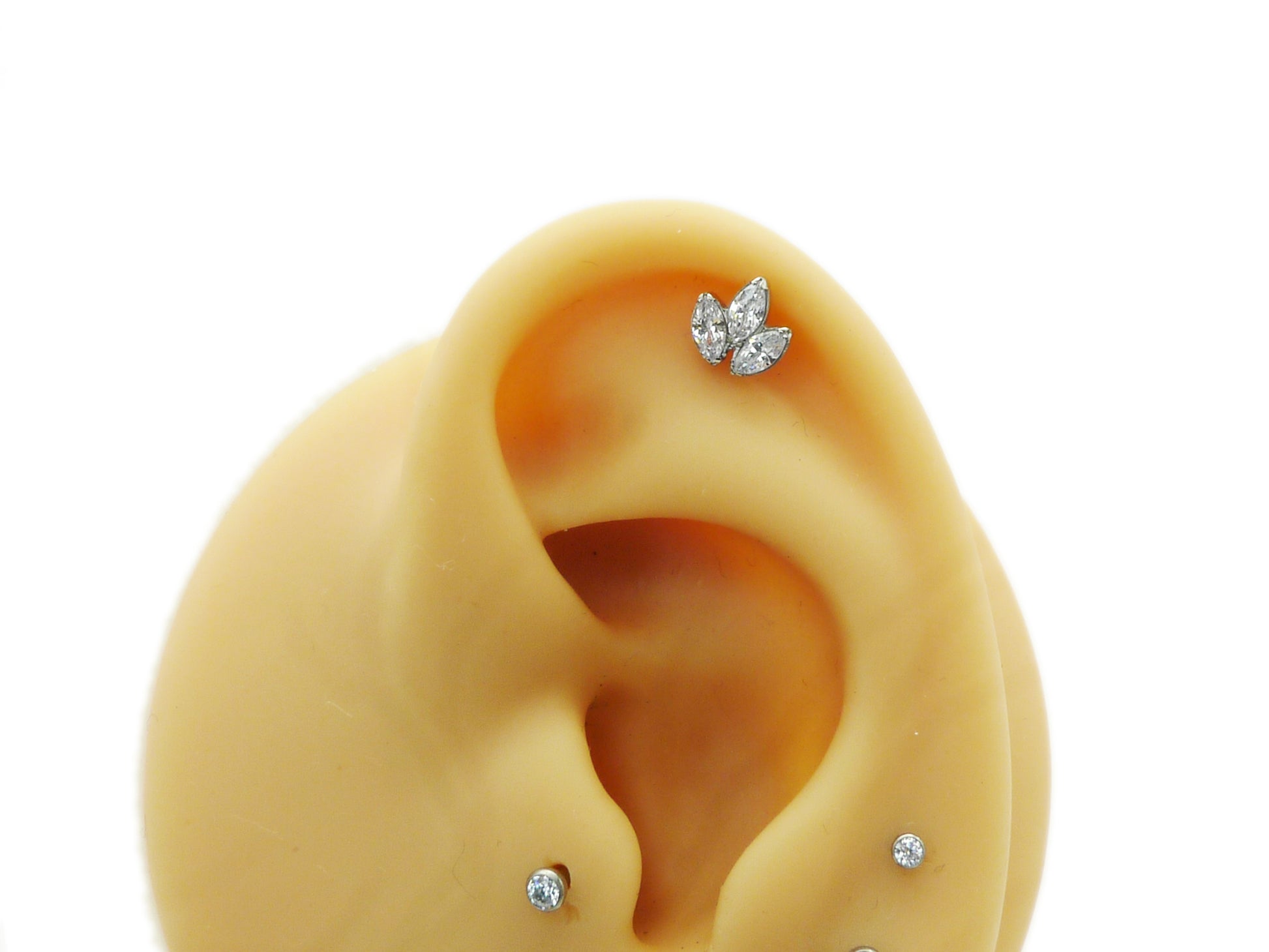 A single titanium push fit marquise lotus stud with a polished finish, featuring three marquise cut zirconias.