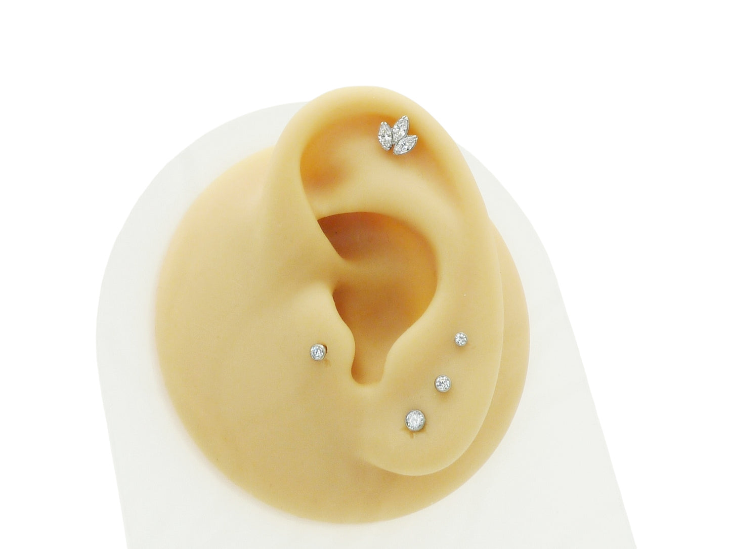 A single titanium push fit marquise lotus stud with a polished finish, featuring three marquise cut zirconias.