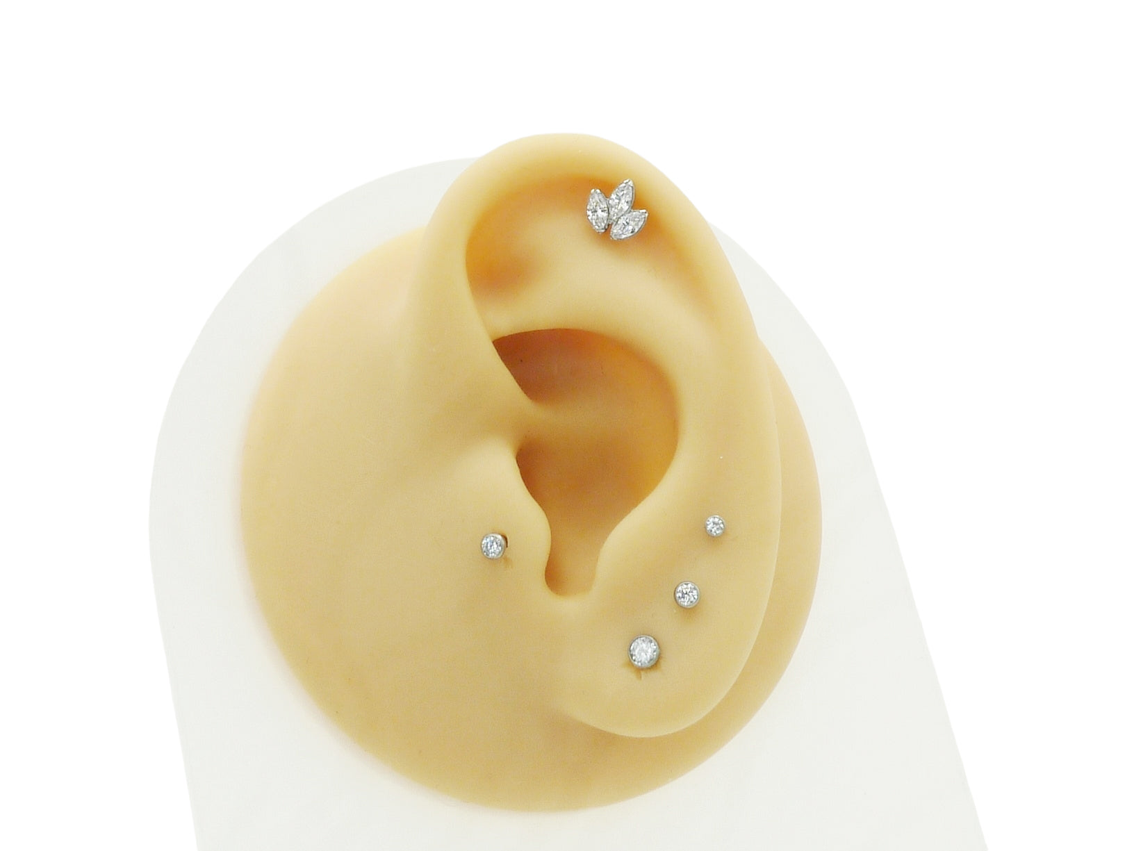 A single titanium push fit marquise lotus stud with a polished finish, featuring three marquise cut zirconias.