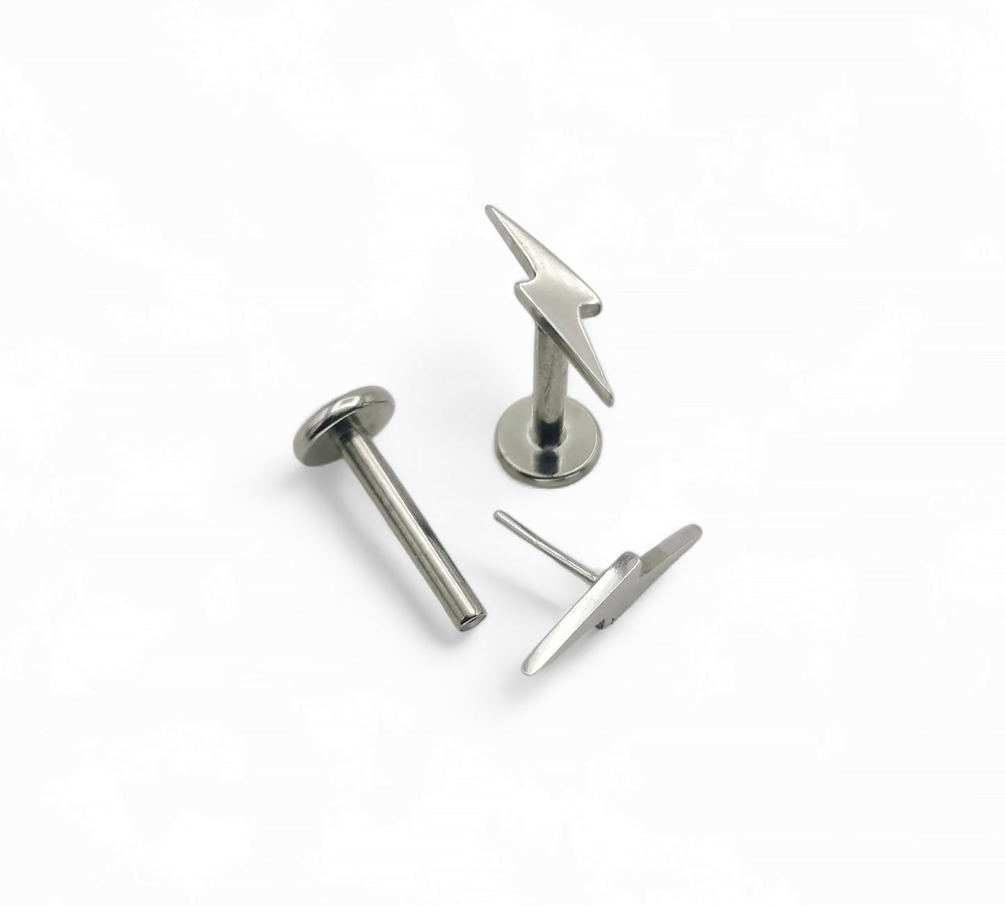 A polished titanium push-fit lightening bolt stud with a surgical steel bolt top, available in various lengths displayed against a white background.