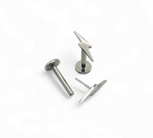 A polished titanium push-fit lightening bolt stud with a surgical steel bolt top, available in various lengths displayed against a white background.