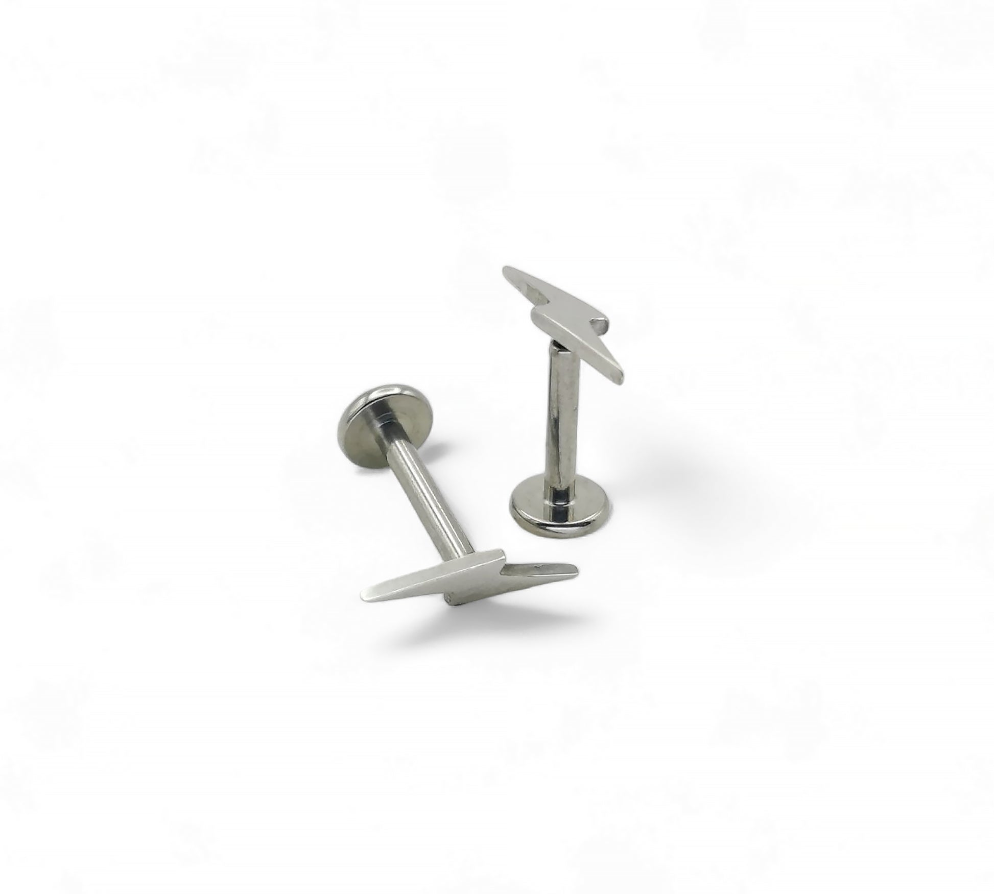 Pair of silver lightening bolt studs on a white background