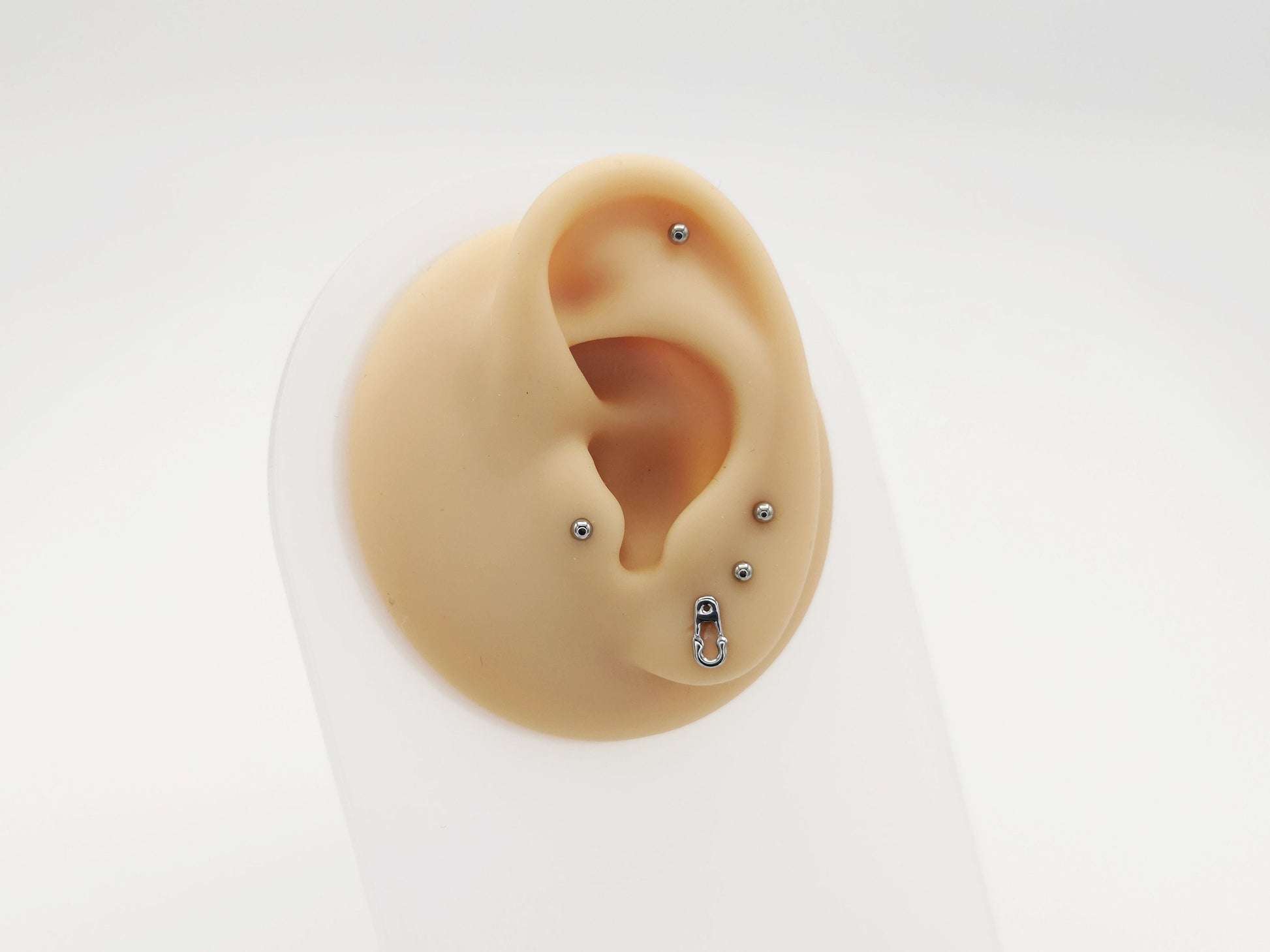 Titanium safety pin stud on a mannequin ear