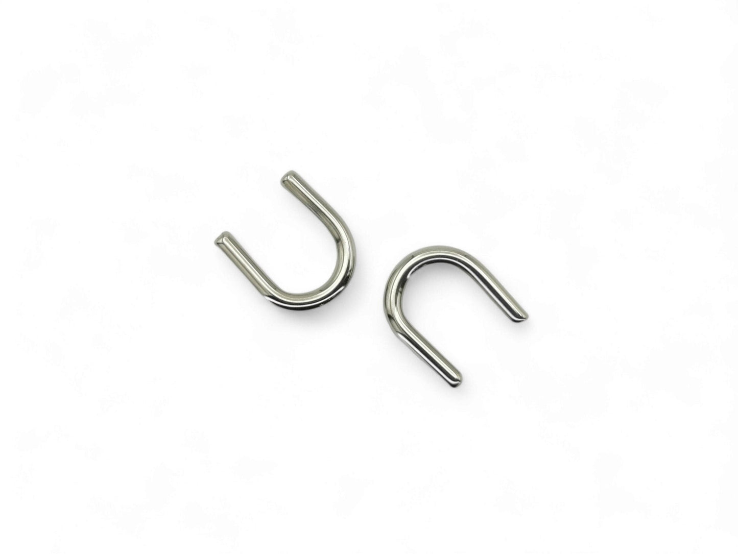 Titanium septum keepers on a white background