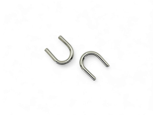 Titanium septum keepers on a white background
