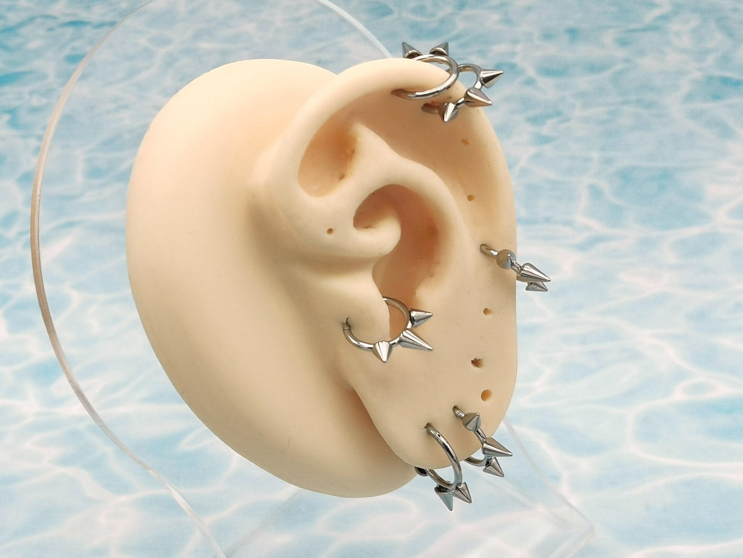 Titanium spike clickers on a manikin ear 