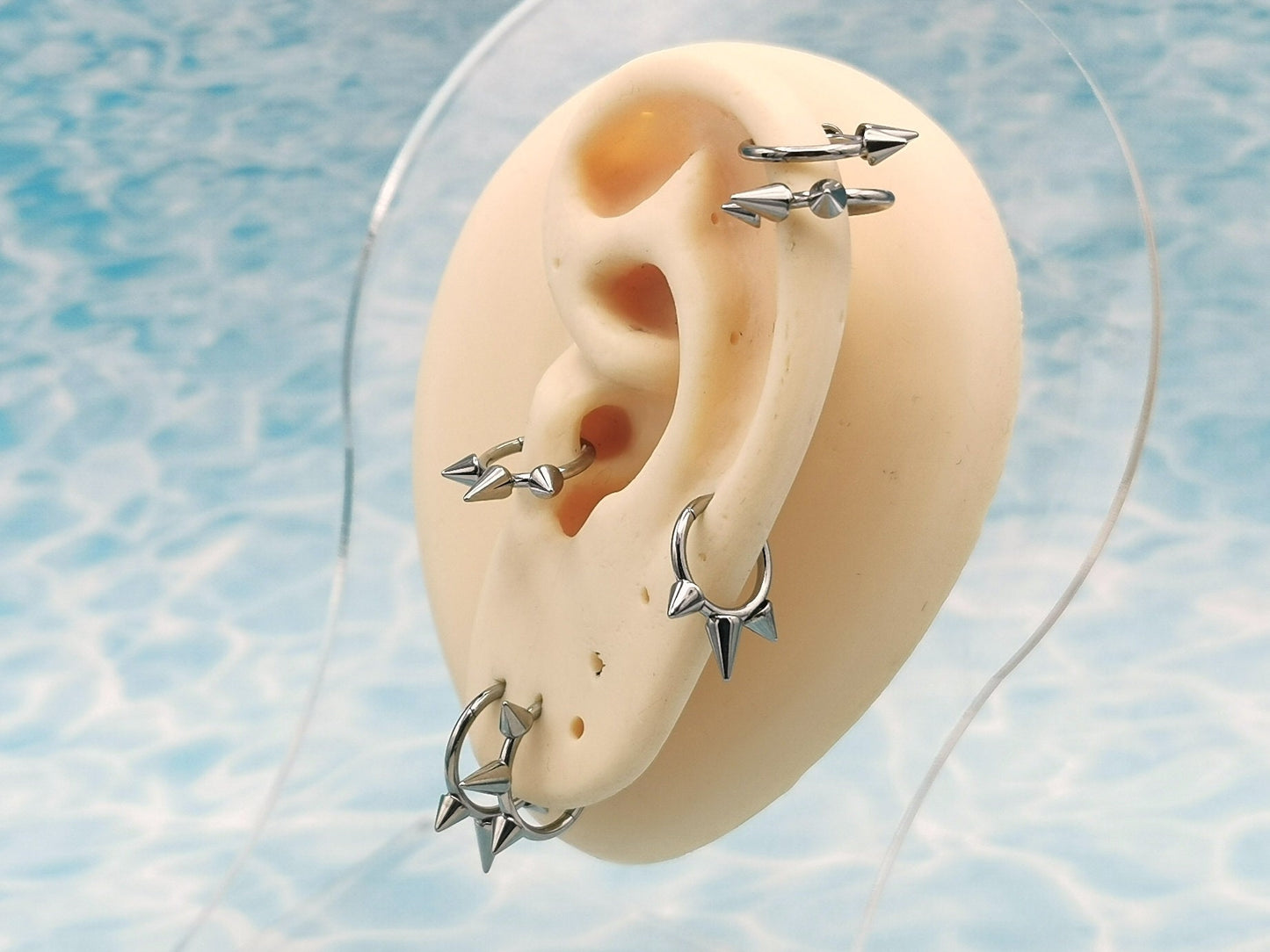 Titanium spike clickers on a manikins ear