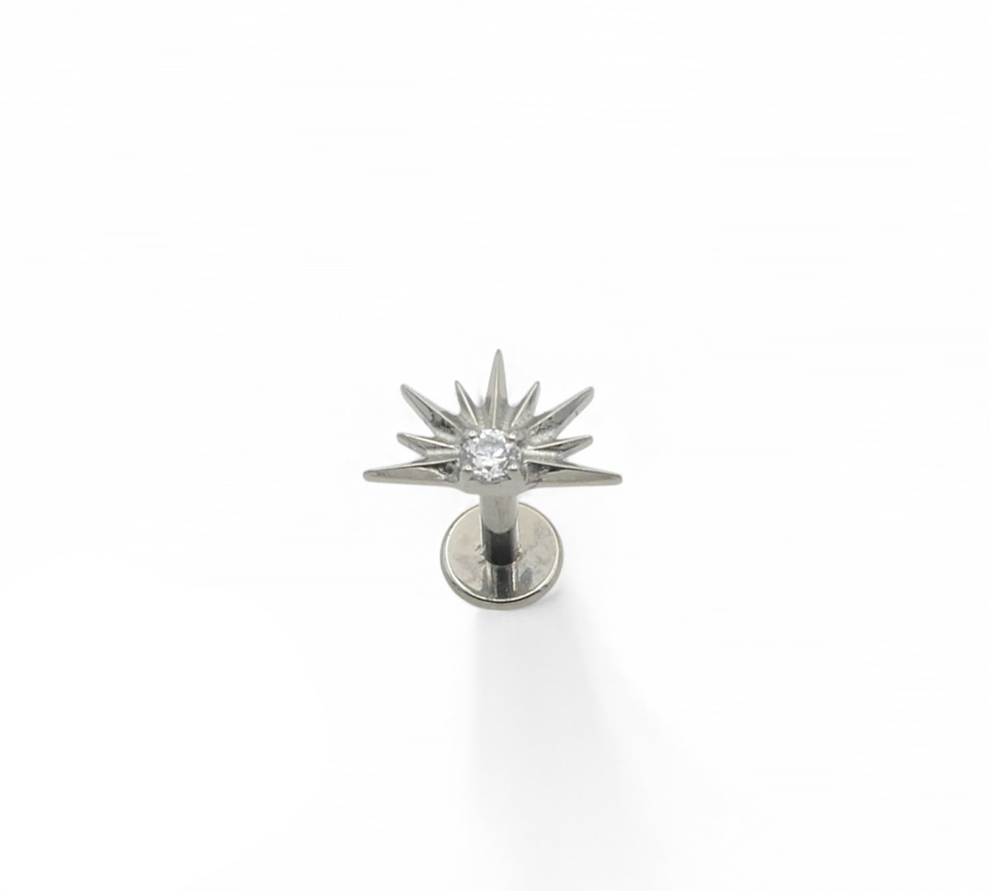 A silver-colored titanium stud earring with a claw-set cubic zirconia, designed for piercing.
