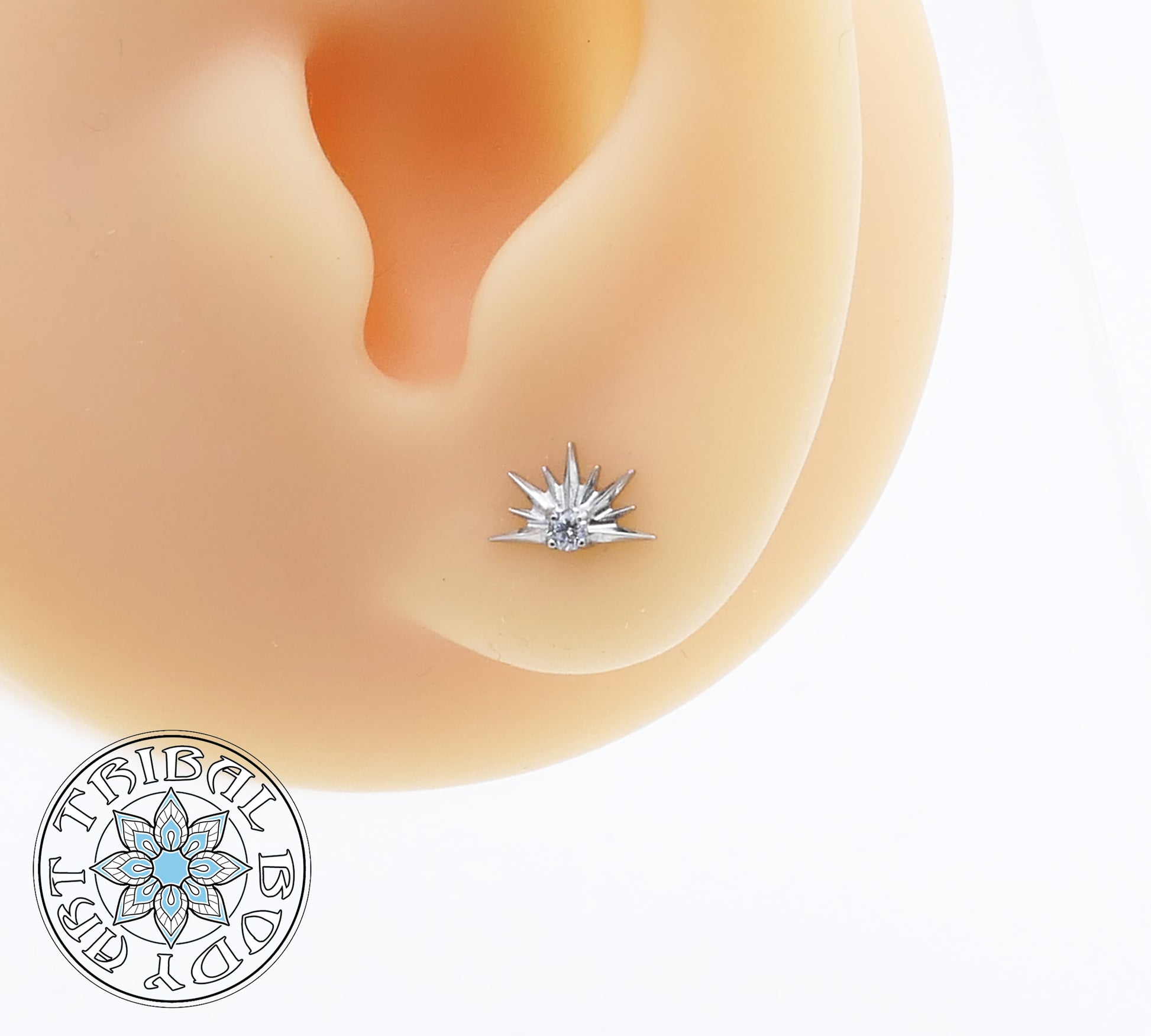 Star-shaped earring on a person's ear with a visible brand logo.