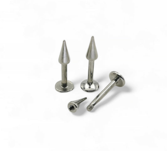 A collection of titanium spike labret studs in various lengths, with a flat disc back, displayed on a white background.