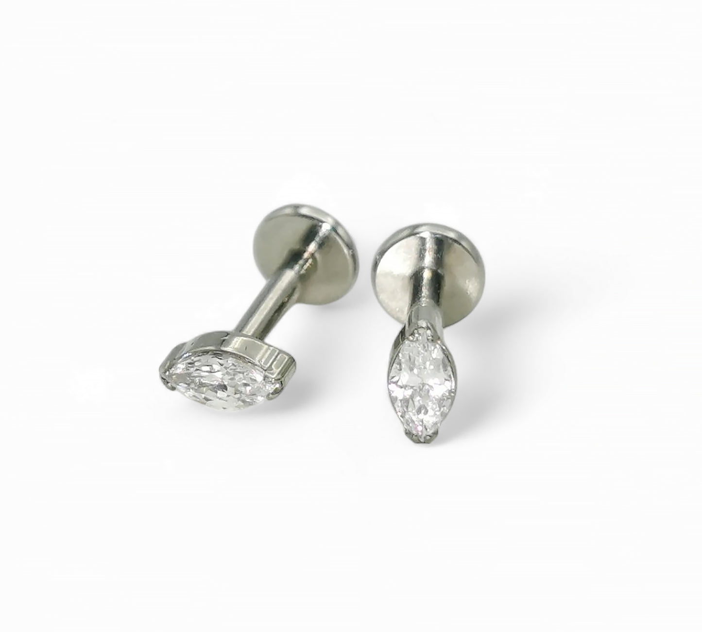 A pair of titanium threadless stud earrings with marquise-shaped bezel-set cubic zirconia, displayed against a white background.