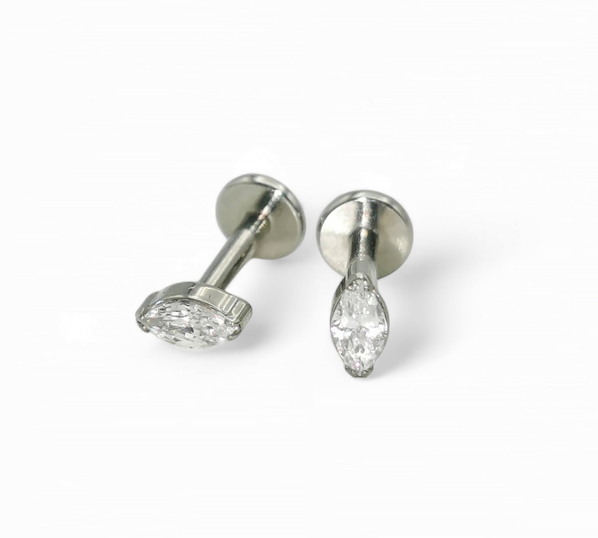 A pair of titanium threadless stud earrings with marquise-shaped bezel-set cubic zirconia, displayed against a white background.