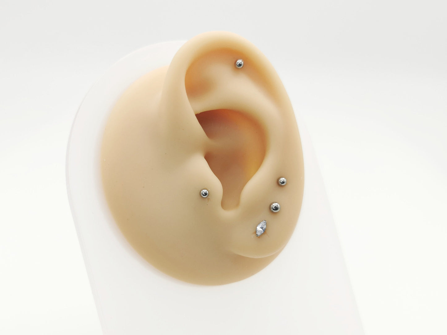 Titanium threadless jewelled marquise stud on a mannequin ear