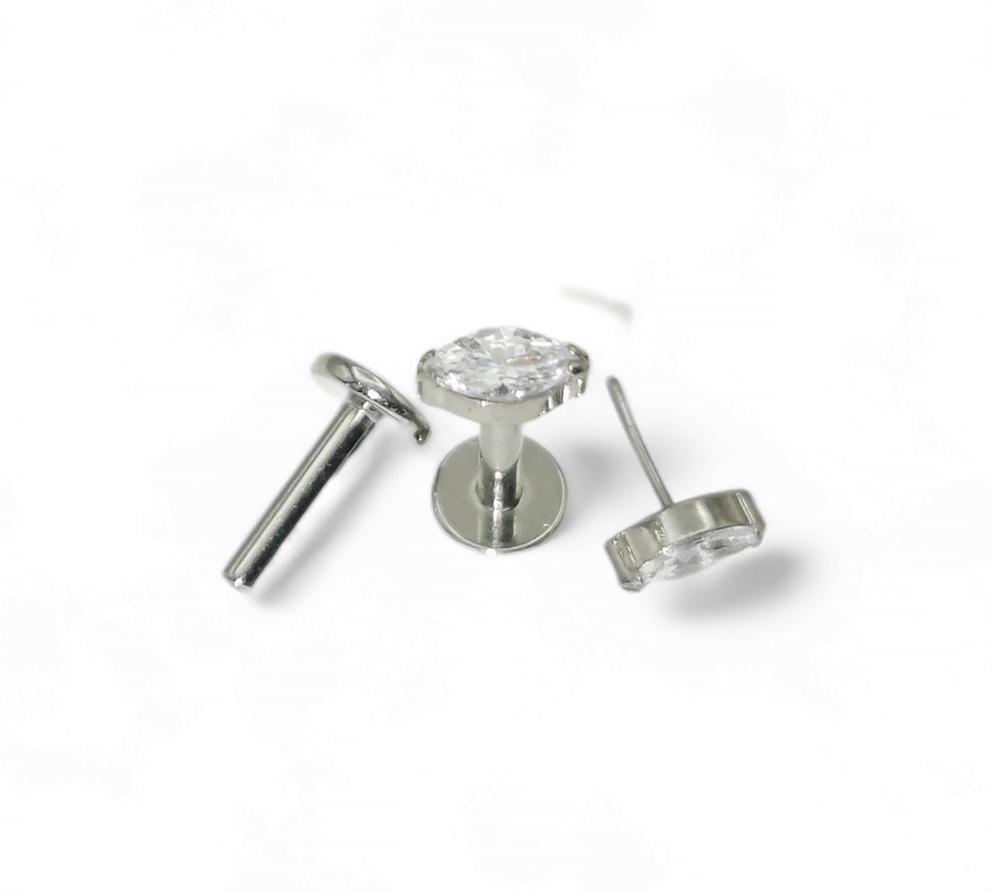Silver earring with clear gemstone on a white background