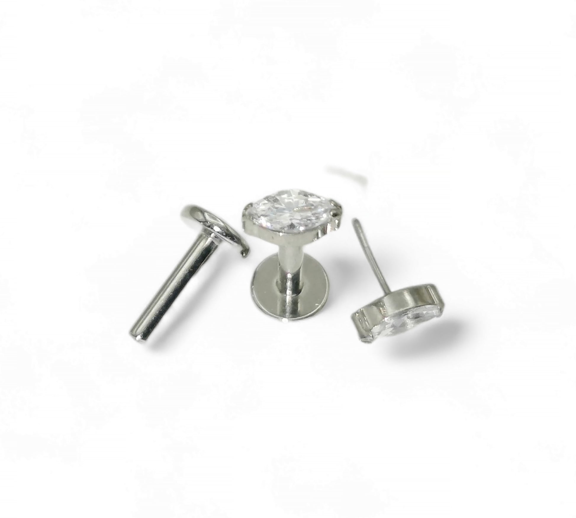 Silver earring with clear gemstone on a white background