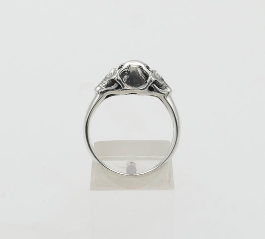 Silver double skull ring on a white background