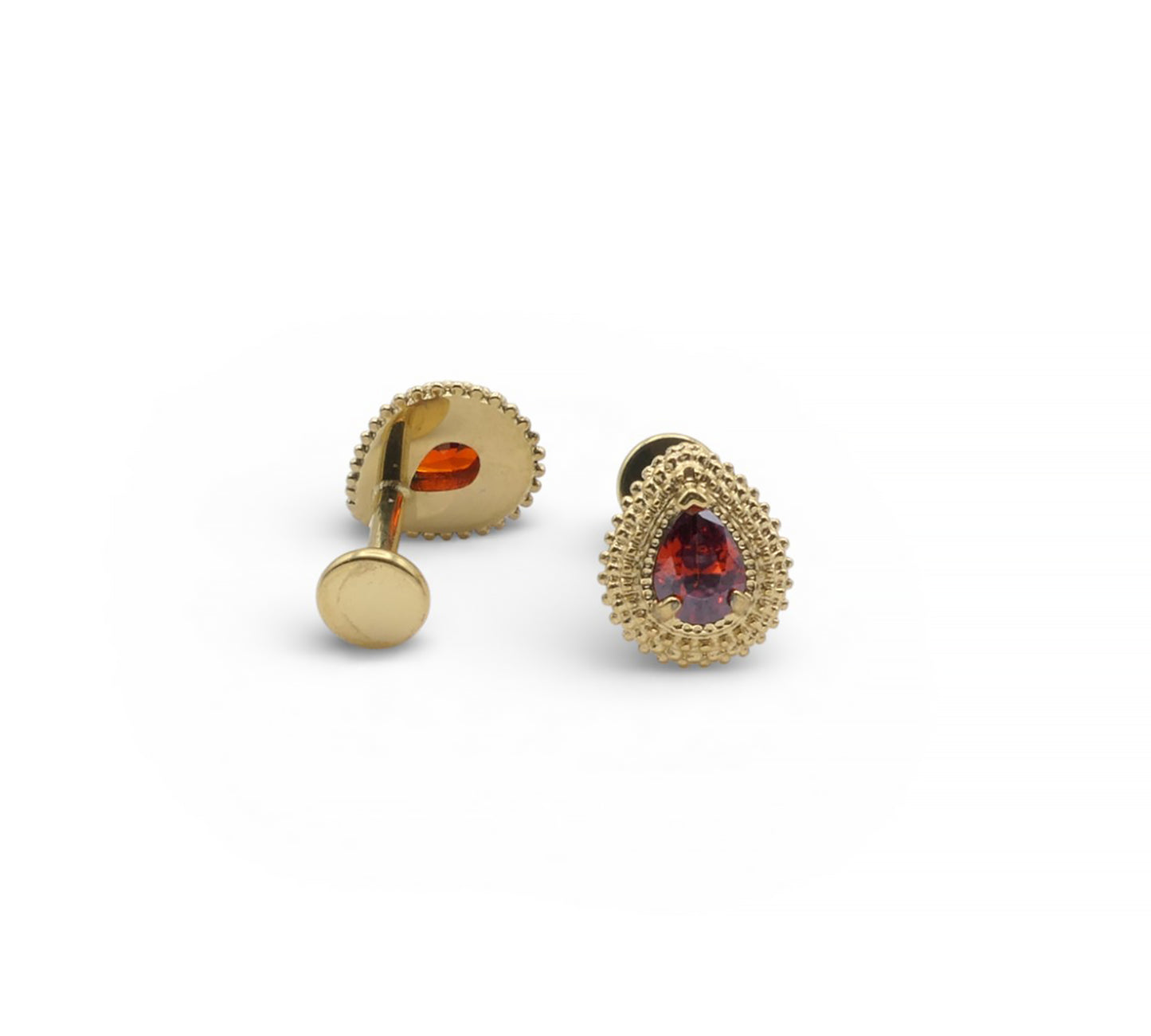 Gold earrings with red gemstones on a white background