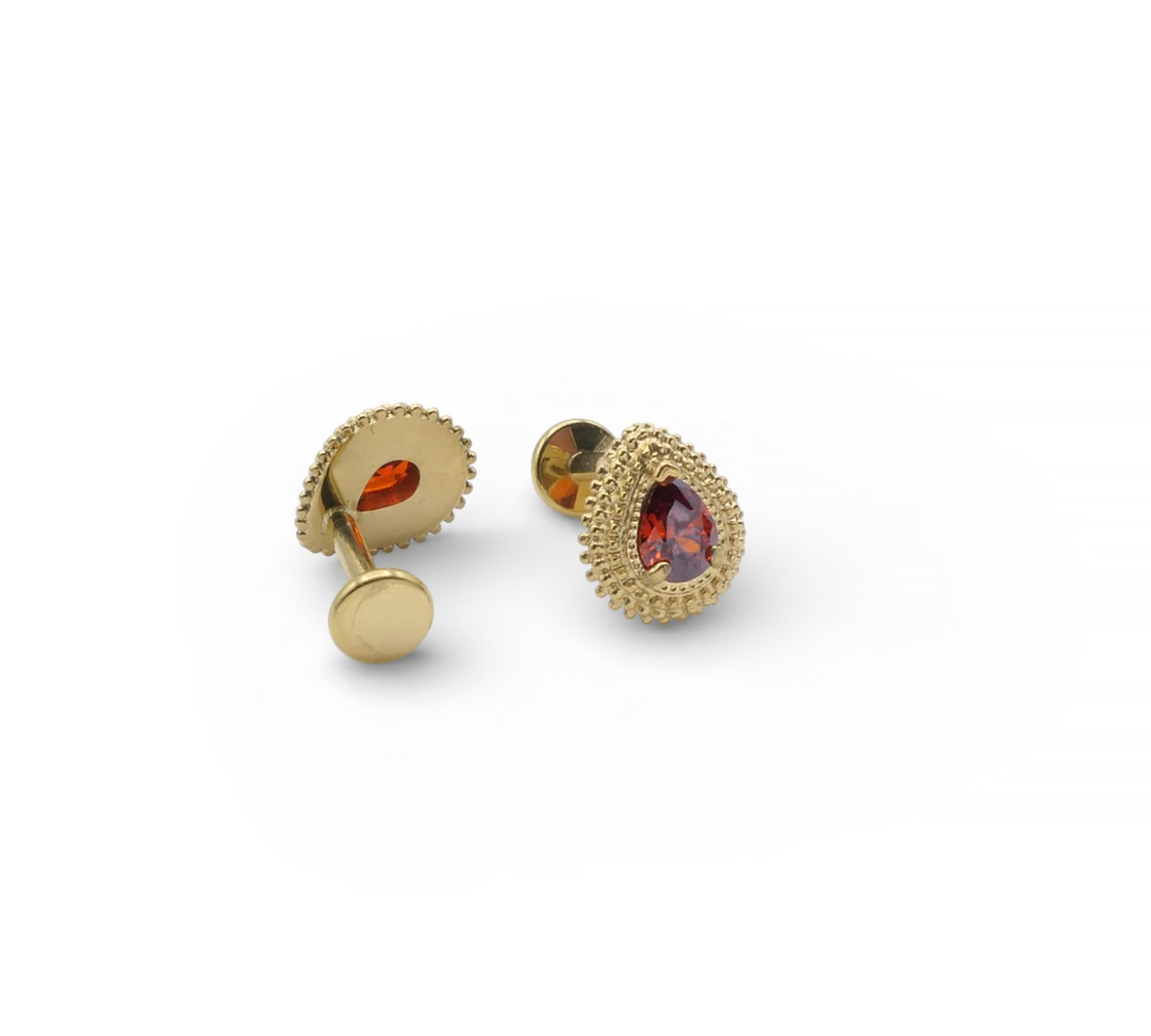 Gold earrings with red gemstones on a white background