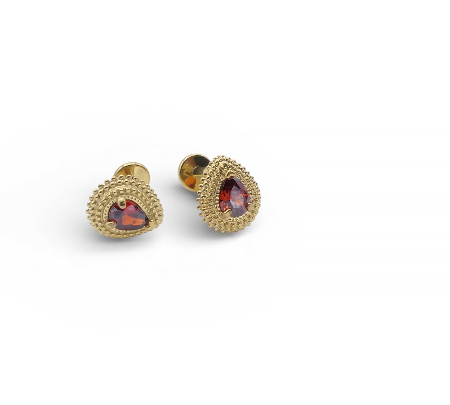 Gold earrings with red gemstones on a white background