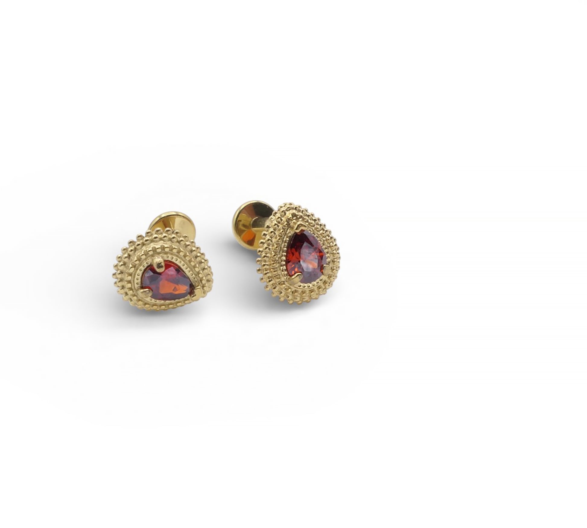 Gold earrings with red gemstones on a white background